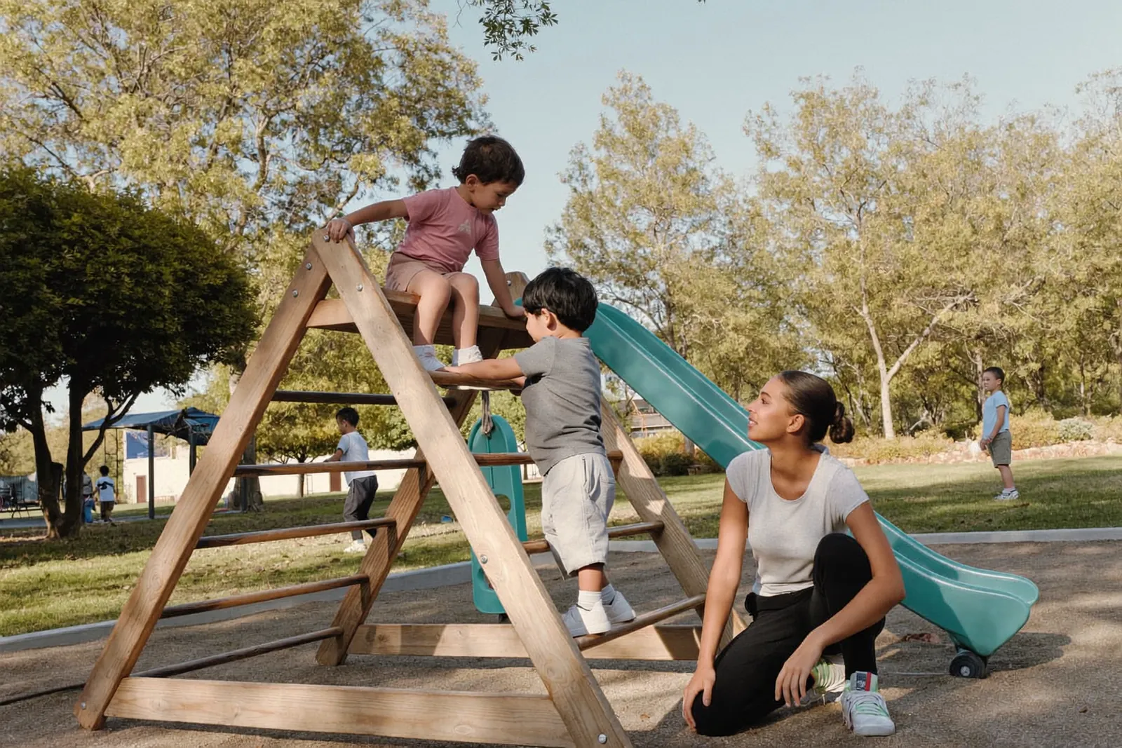 Children playing in a nursery garden with a caregiver
